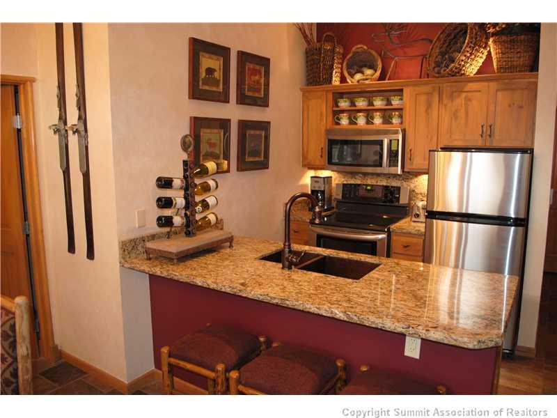 195 River Run Road, Unit 8072 Keystone, CO 80435 - Photo 1 of 7 a kitchen with stainless steel appliances granite countertop a refrigerator and a stove
