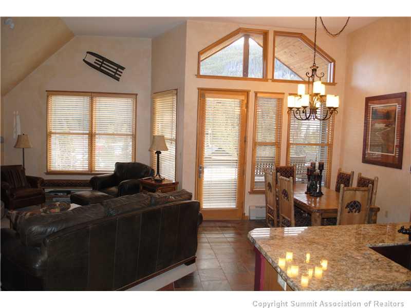 195 River Run Road, Unit 8072 Keystone, CO 80435 - Photo 2 of 7 a living room with furniture a flat screen tv and large windows