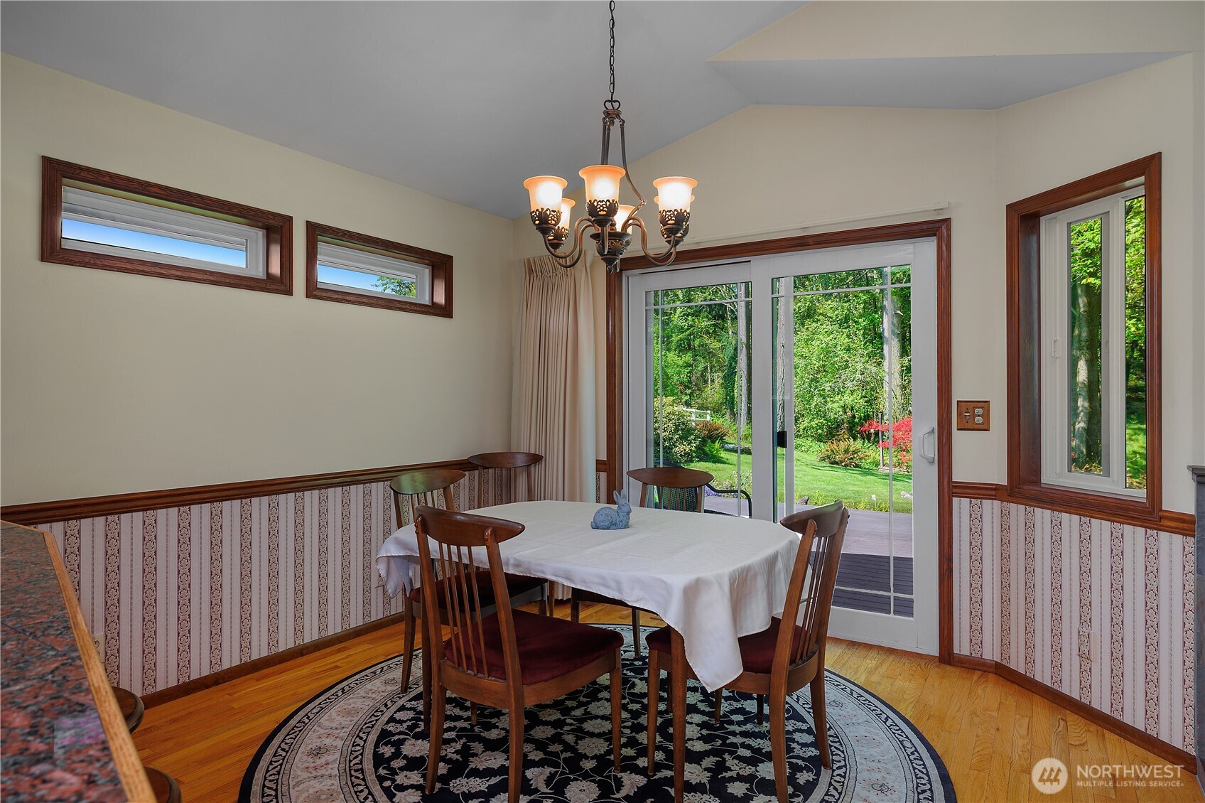 5629 Sleater Kinney Road Northeast Olympia, WA 98506 - Photo 15 of 32 a view of a dining room with furniture a chandelier and wooden floor