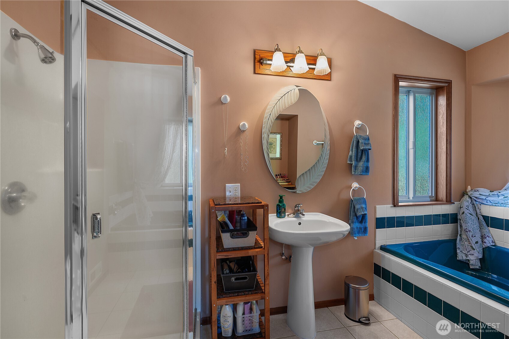 5629 Sleater Kinney Road Northeast Olympia, WA 98506 - Photo 22 of 32 a bathroom with a sink a mirror and a window