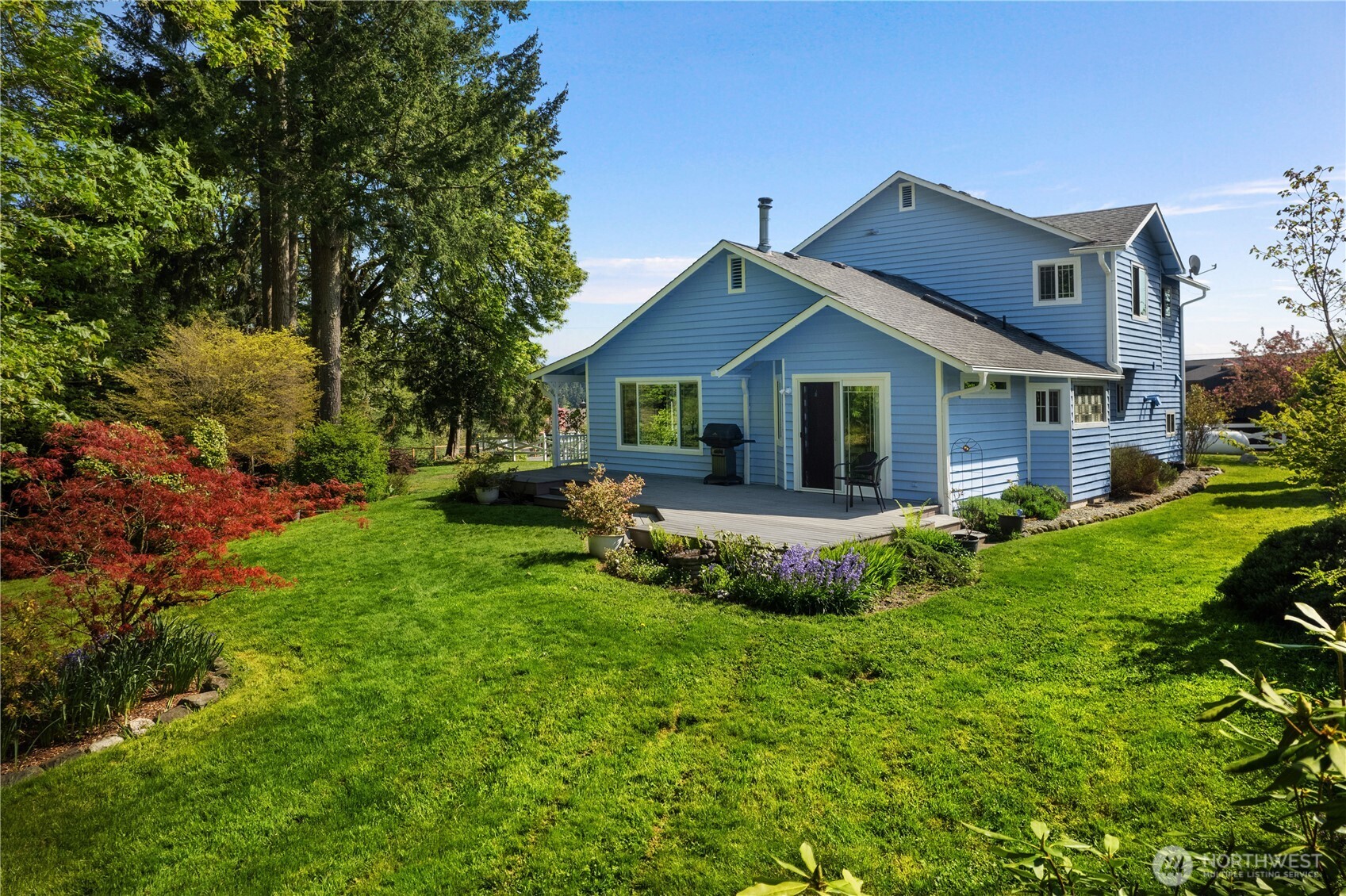 5629 Sleater Kinney Road Northeast Olympia, WA 98506 - Photo 28 of 32 a view of house with a big yard potted plants and large tree