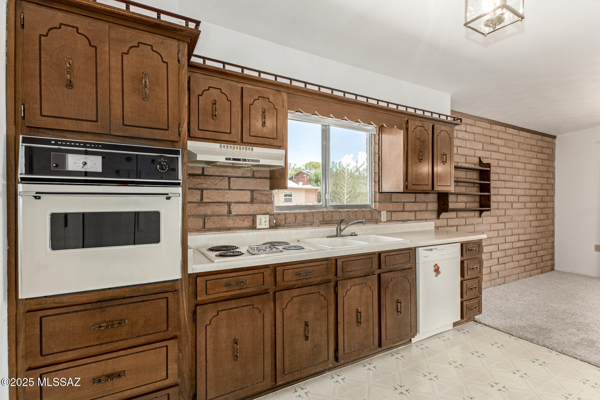 16381 South Observatory Place Vail, AZ 85641 - Photo 6 of 23 a kitchen with stainless steel appliances granite countertop a sink stove and cabinets