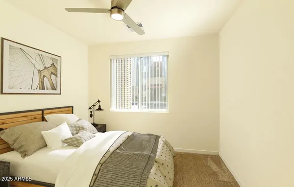 a bedroom with a bed and the window