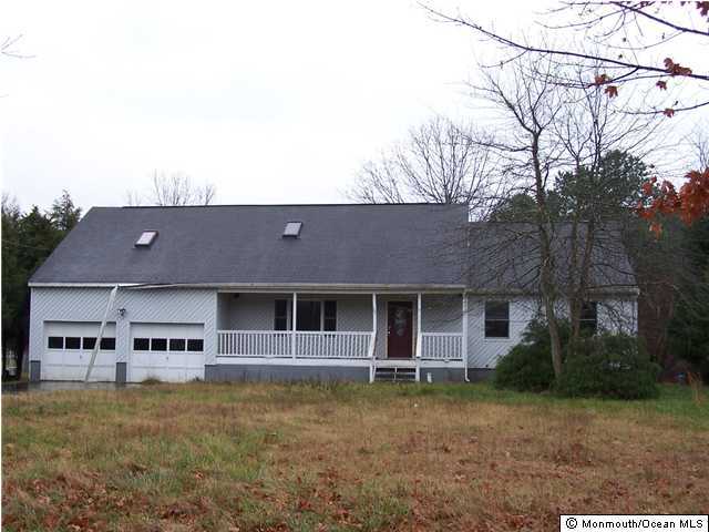 591 Reed Road Jackson, NJ 08527 - Photo 1 of 3 front view of house with a yard and potted plants