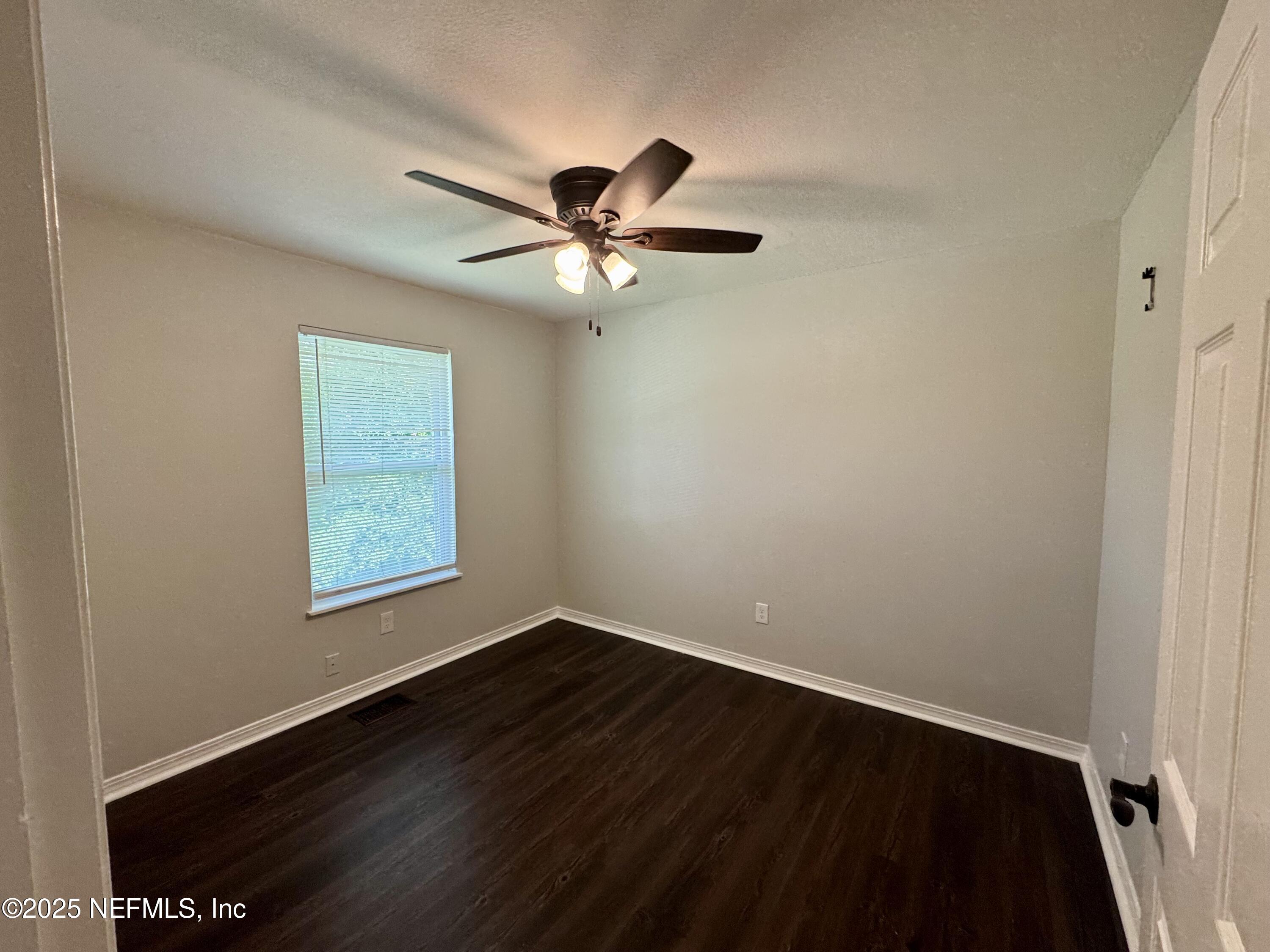 707 Rainer Road, Unit 3 Baldwin, FL 32234 - Photo 7 of 11 an empty room with a window and a fan