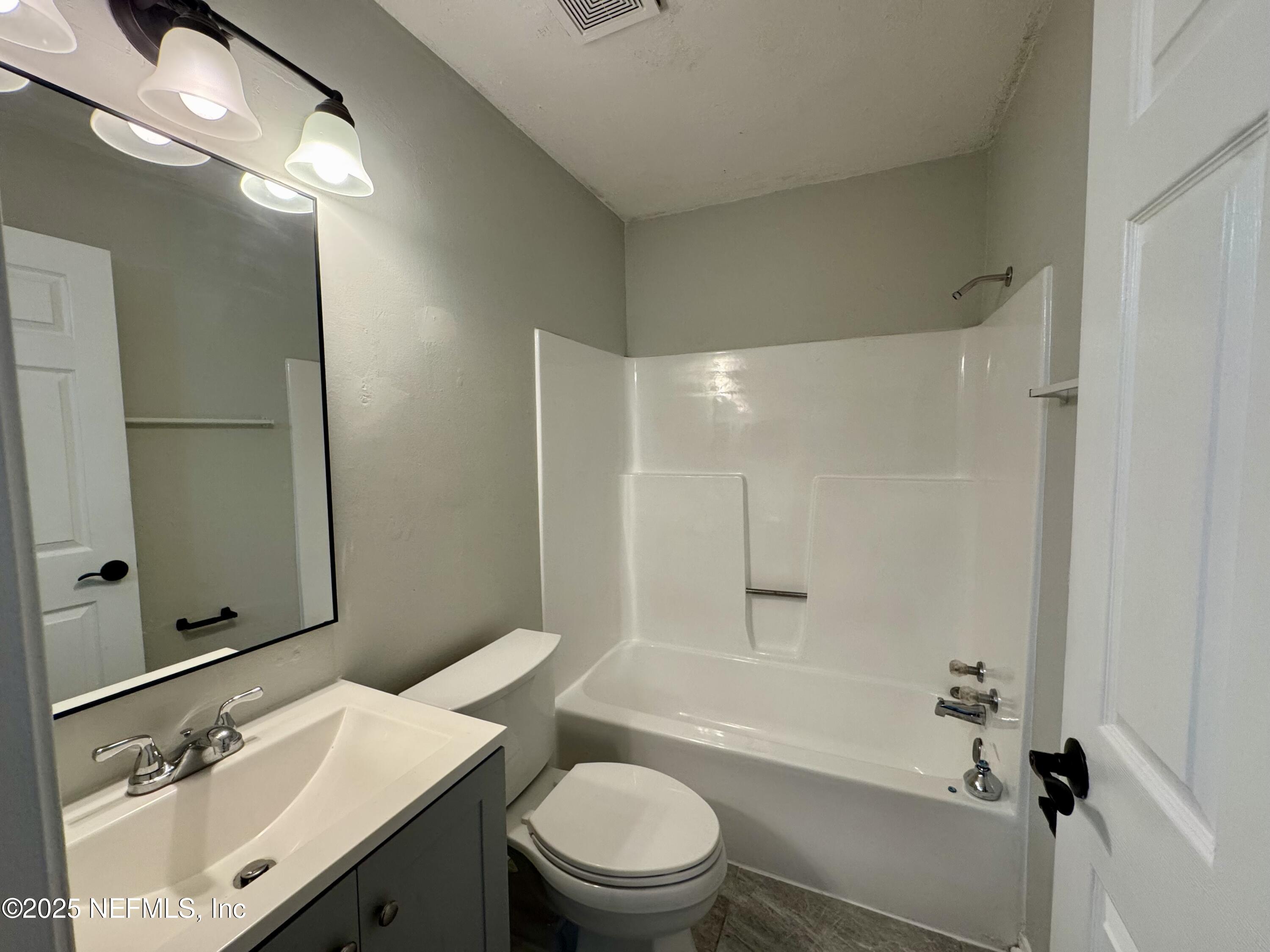 707 Rainer Road, Unit 3 Baldwin, FL 32234 - Photo 8 of 11 a bathroom with a sink a toilet and shower
