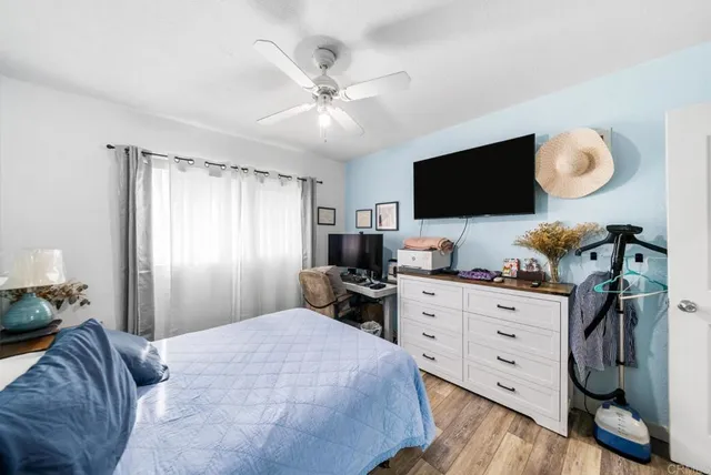 a bedroom with a bed and flat screen tv