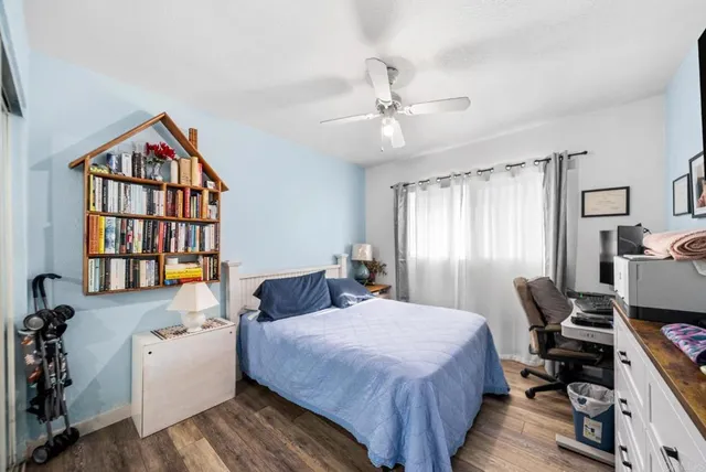 a spacious bedroom with a bed and a book shelf