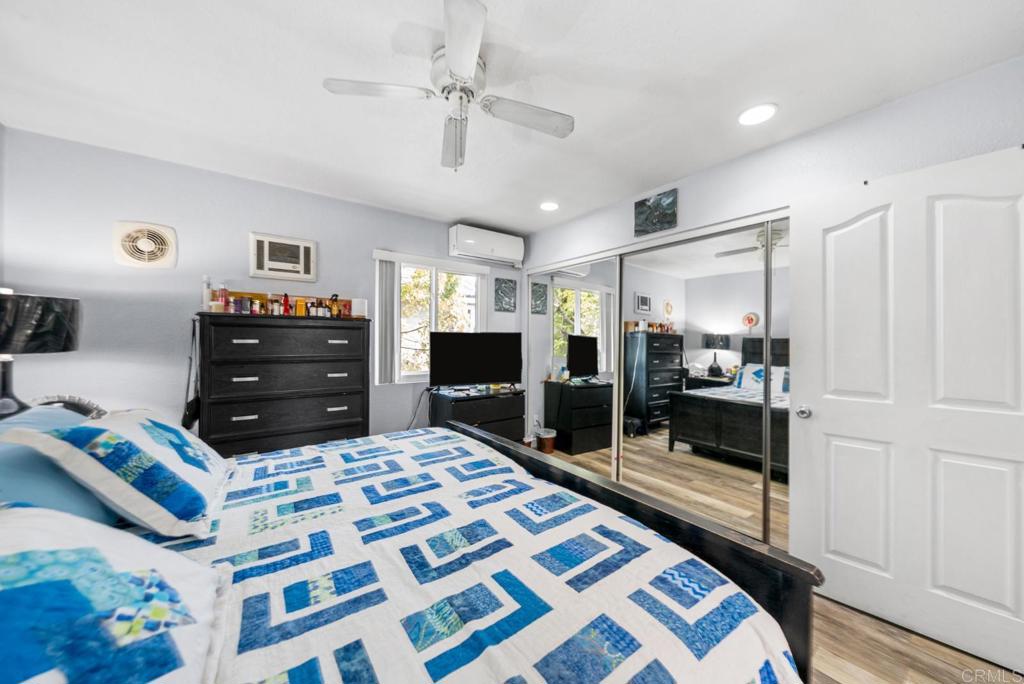 500 Telegraph Canyon Road, Unit H Chula Vista, CA 91910 - Photo 18 of 36 a large bedroom with a bed and a chandelier