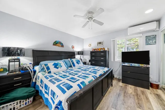a bedroom with a bed and flat screen tv