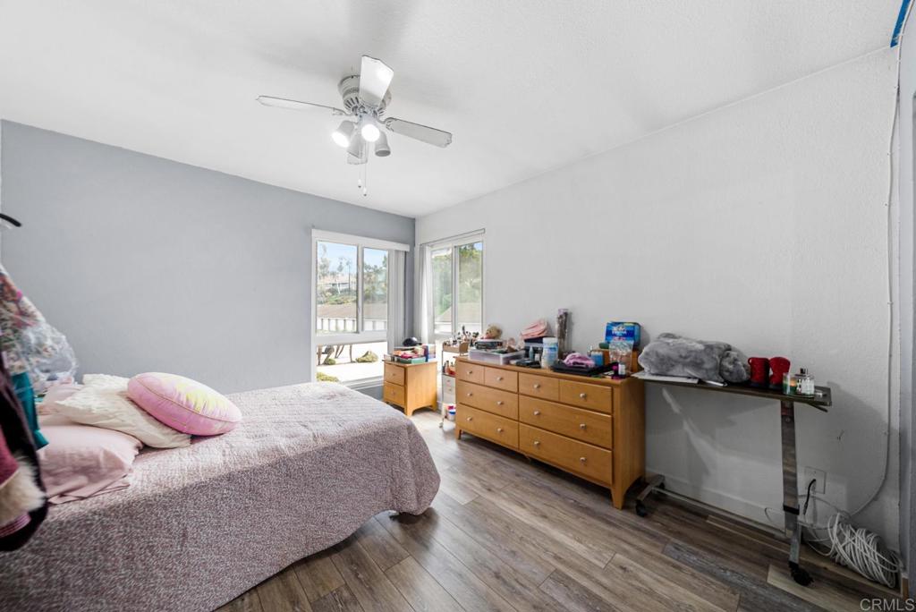 500 Telegraph Canyon Road, Unit H Chula Vista, CA 91910 - Photo 20 of 36 a bedroom with a bed and a chandelier