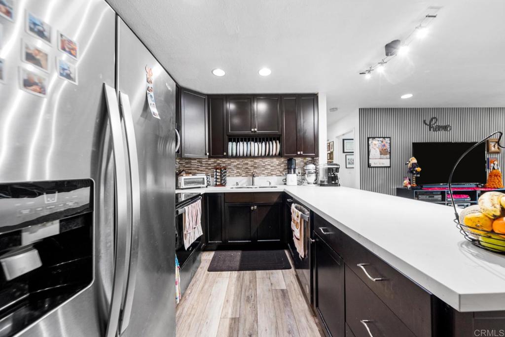500 Telegraph Canyon Road, Unit H Chula Vista, CA 91910 - Photo 3 of 36 a kitchen with a refrigerator and a sink
