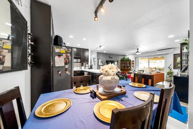 a dining room with furniture and wooden floor
