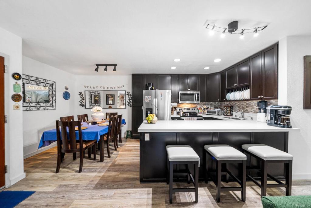 500 Telegraph Canyon Road, Unit H Chula Vista, CA 91910 - Photo 10 of 36 a living room with stainless steel appliances kitchen island granite countertop furniture and kitchen view