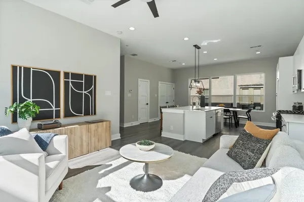 a kitchen with a sink stove and white cabinets