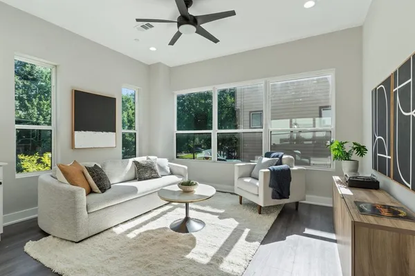 a living room with furniture and kitchen view