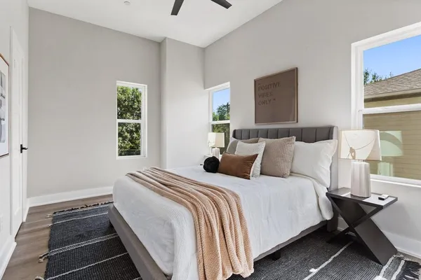 a bedroom with a bed and wooden floor