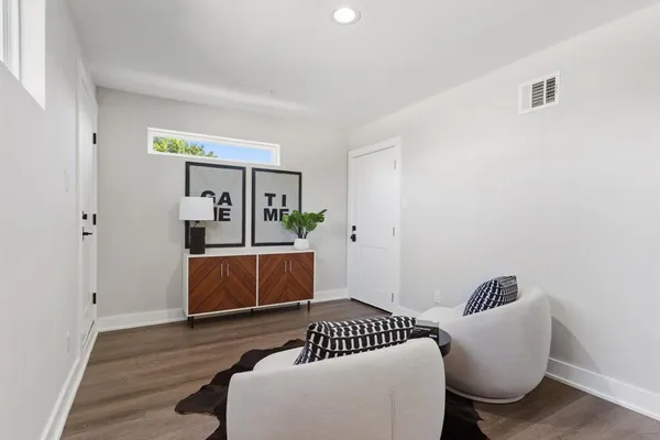 a living room with furniture and a potted plant