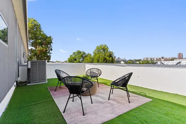 a backyard of a house with table and chairs