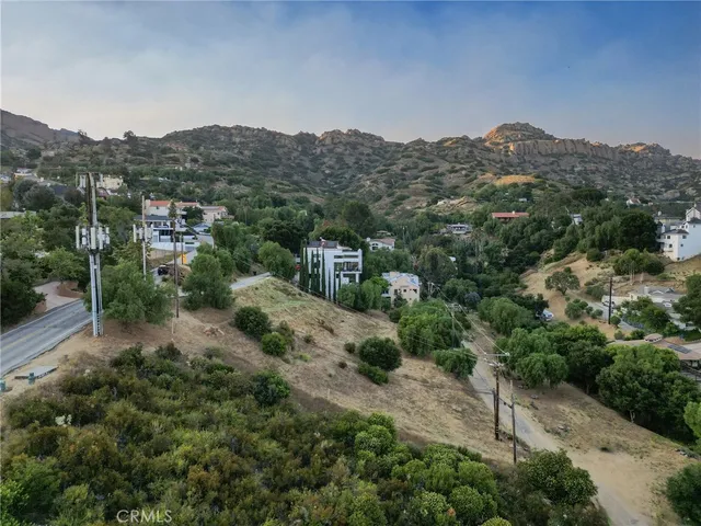 an aerial view of residential house and green space
