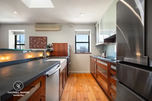 a view of a workspace with furniture and a flat screen tv