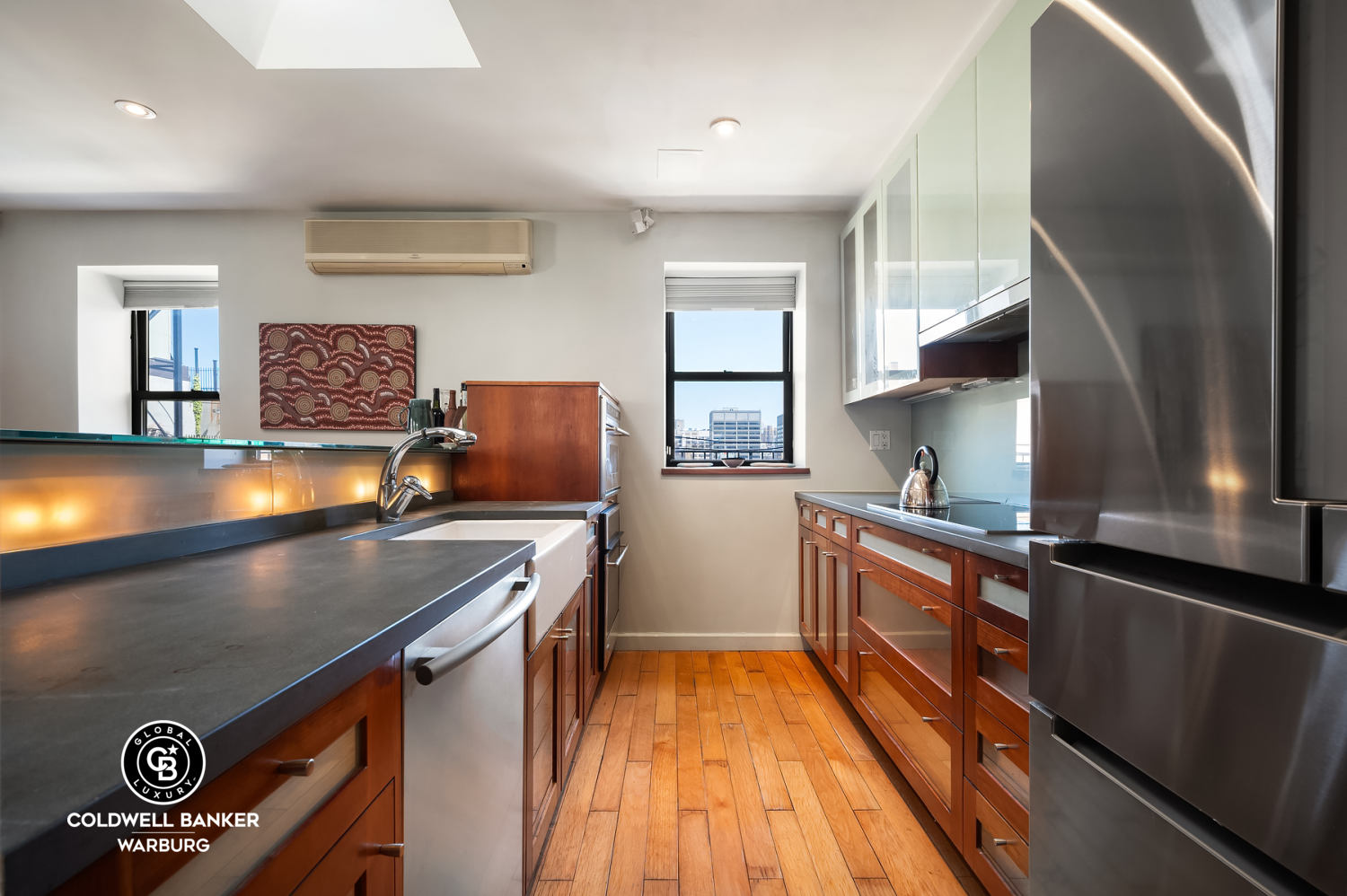115 East 61st Street, Unit PH Manhattan, NY 10065 - Photo 6 of 12 a kitchen with stainless steel appliances granite countertop a stove a sink and a refrigerator