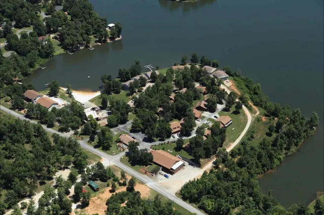 an aerial view of a house with a yard and lake view