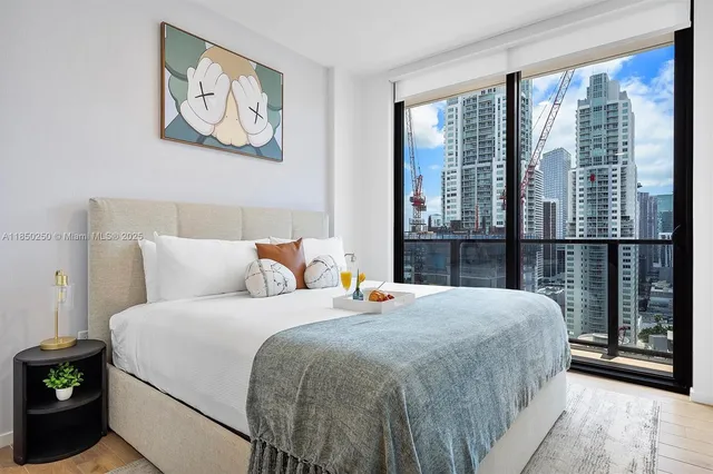 a bedroom with a bed and a large window