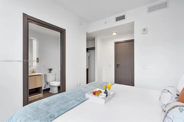 a bedroom with a bed and a view of bathroom