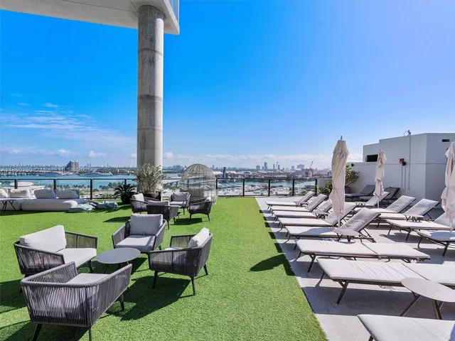 a view of a patio with dining table and chairs