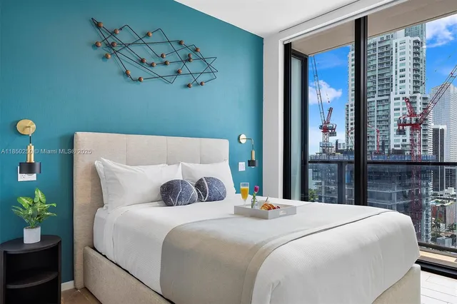 a bedroom with a bed and a potted plant