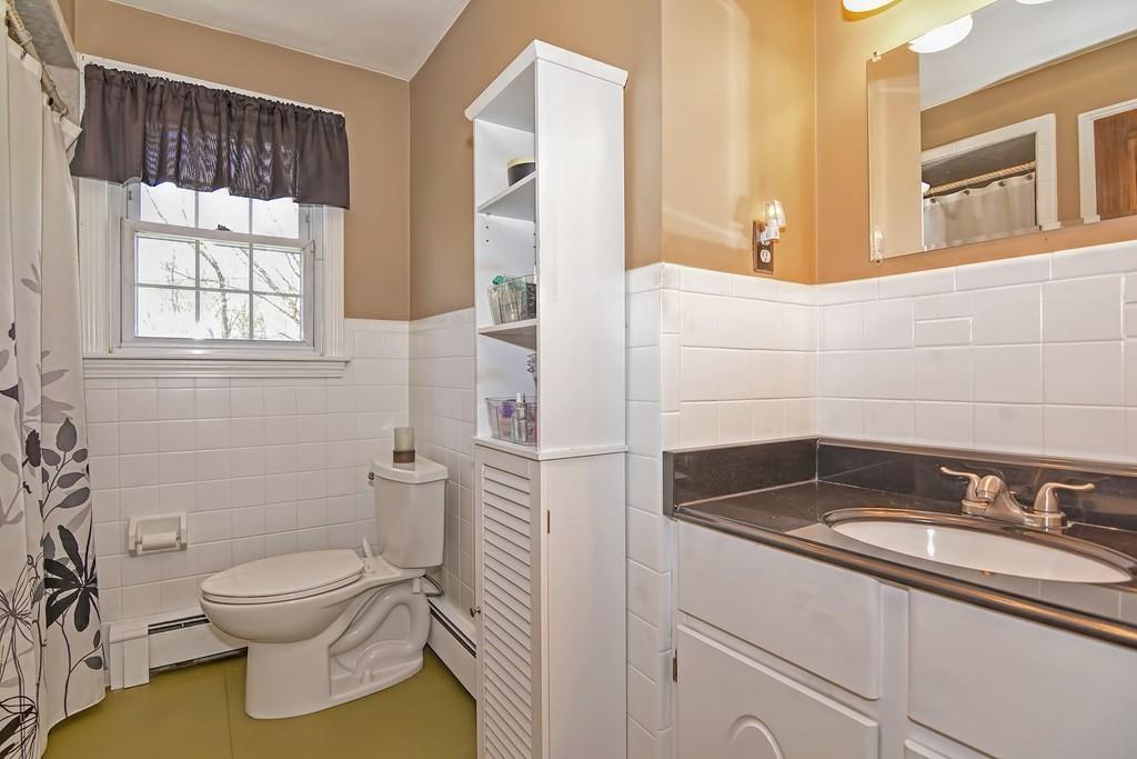 50 Cedarcrest Road Canton, MA 02021 - Photo 19 of 42 a bathroom with a granite countertop toilet a sink and a mirror