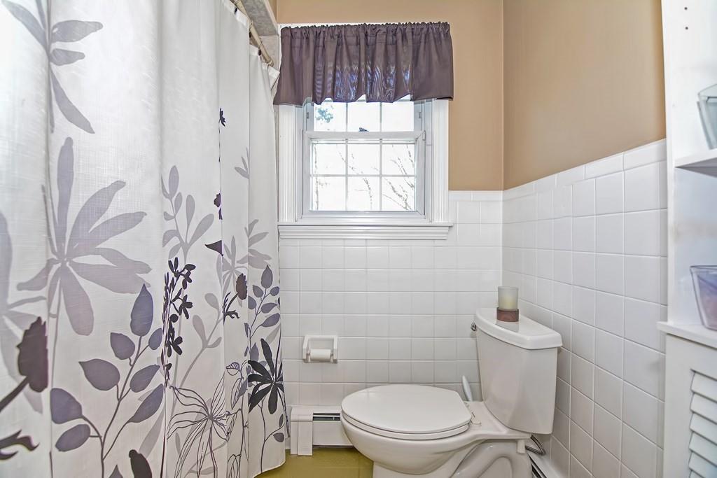 50 Cedarcrest Road Canton, MA 02021 - Photo 20 of 42 a white toilet sitting next to a window and a shower