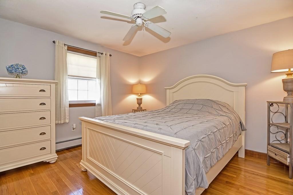 50 Cedarcrest Road Canton, MA 02021 - Photo 21 of 42 a bedroom with a bed and a chandelier