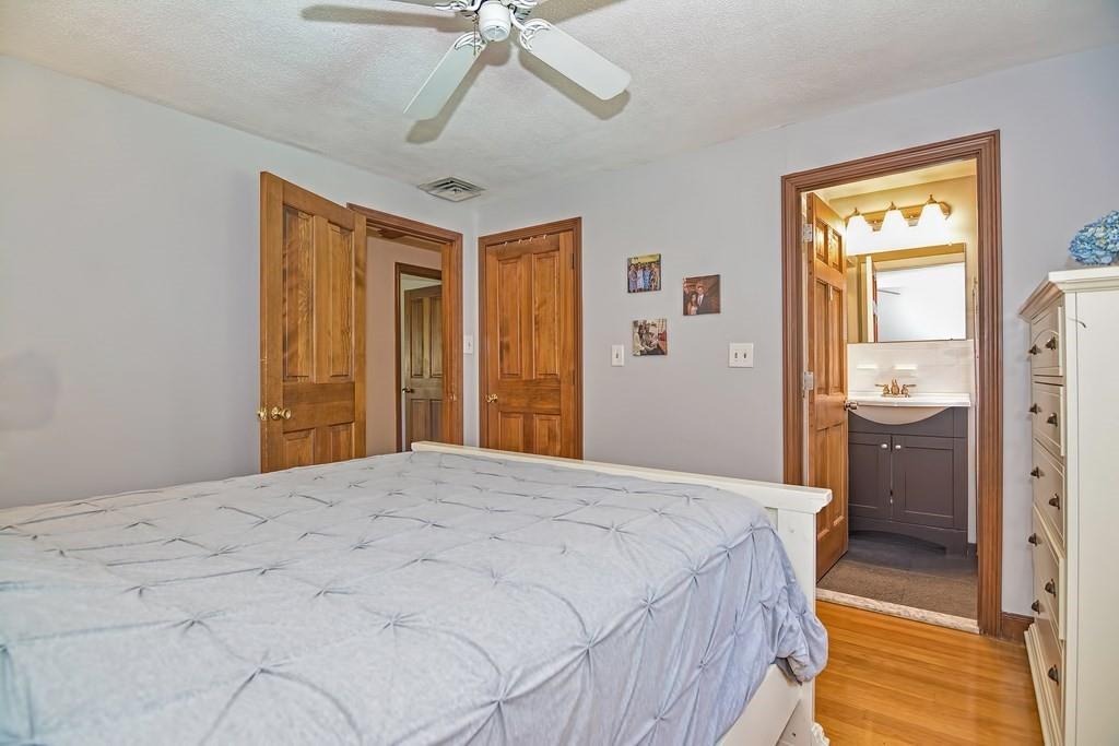 50 Cedarcrest Road Canton, MA 02021 - Photo 22 of 42 a bedroom with a bed and a chandelier