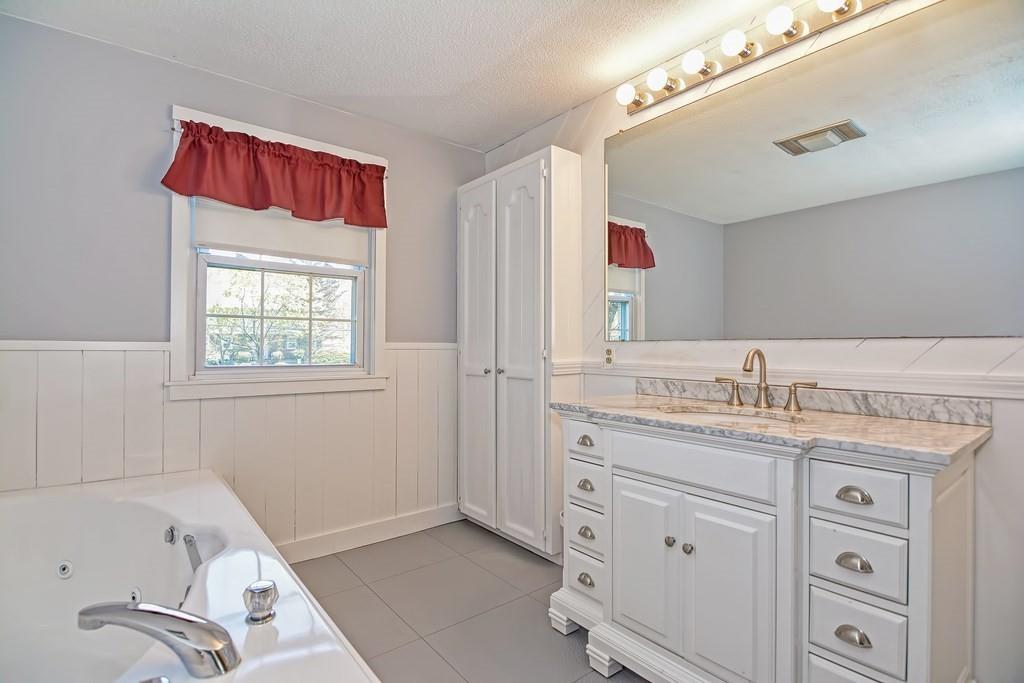 50 Cedarcrest Road Canton, MA 02021 - Photo 26 of 42 a bathroom with a granite countertop sink mirror and a bathtub