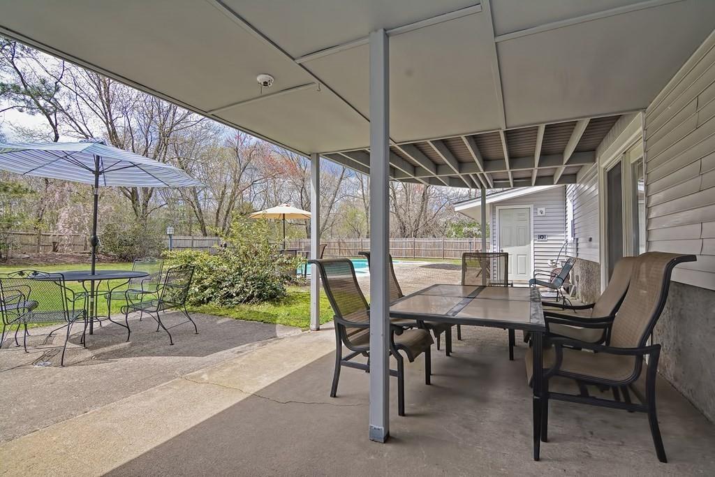 50 Cedarcrest Road Canton, MA 02021 - Photo 40 of 42 a view of a patio with table and chairs under an umbrella