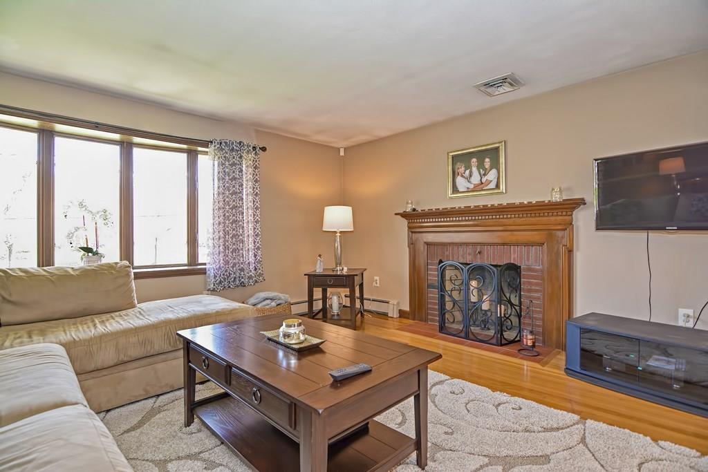 50 Cedarcrest Road Canton, MA 02021 - Photo 6 of 42 a living room with furniture a flat screen tv and a fireplace