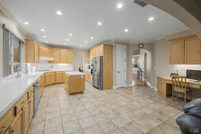 a bed room with a bed a television and a window