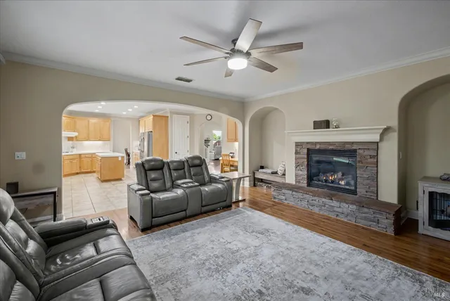 a view of a hallway with wooden floor and stairs