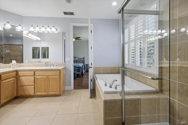 a view of a patio with table and chairs with wooden floor and plants