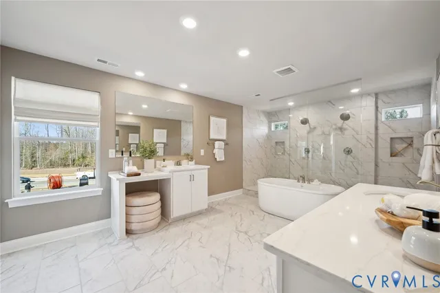 a large bathroom with a double vanity sink a large mirror and a bathtub