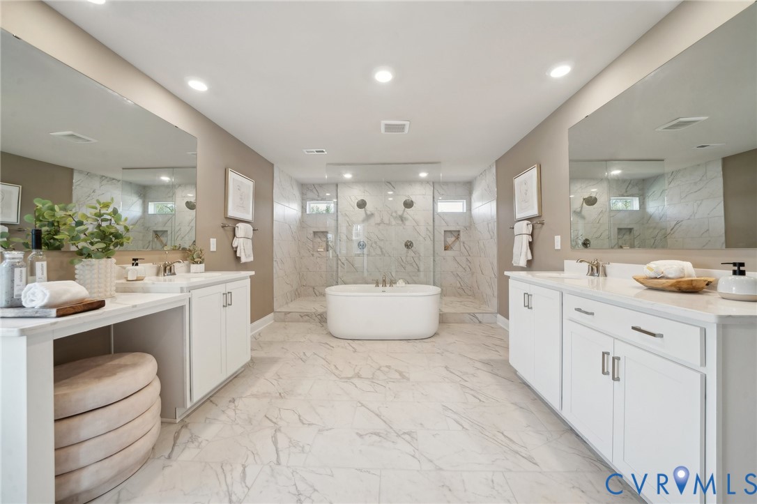 16800 Barmer Road Chesterfield, VA 23832 - Photo 14 of 28 a large bathroom with a double vanity sink a large mirror and a bathtub