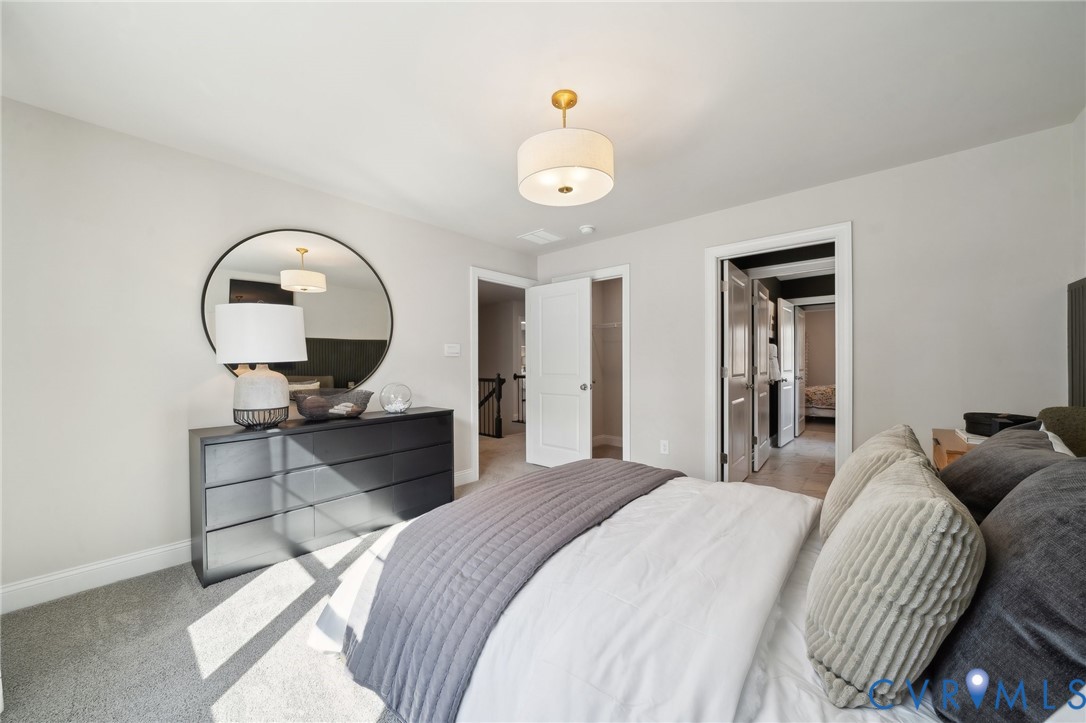 16800 Barmer Road Chesterfield, VA 23832 - Photo 23 of 28 a bedroom with a bed and a chandelier