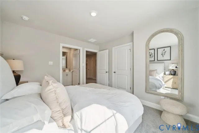 a bathroom with a granite countertop toilet sink and mirror