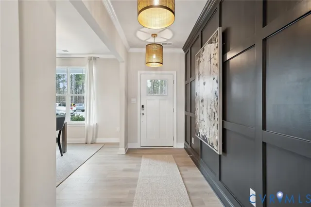 a view of an entryway with wooden floor and mirror