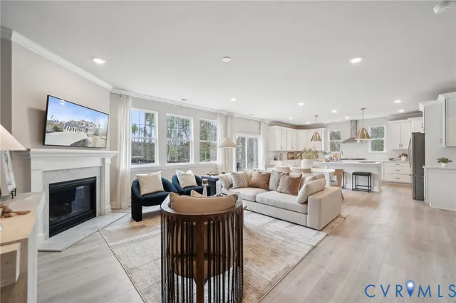 a living room with furniture a fireplace and a large window