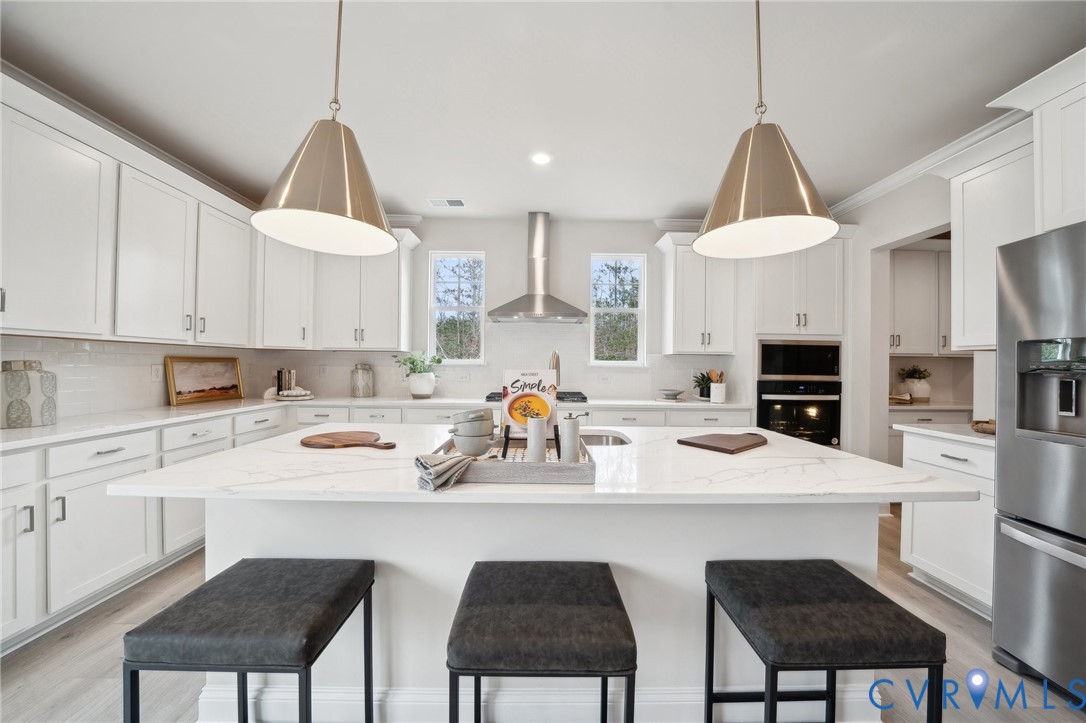 16800 Barmer Road Chesterfield, VA 23832 - Photo 8 of 28 a kitchen with a sink a stove a refrigerator and white cabinets