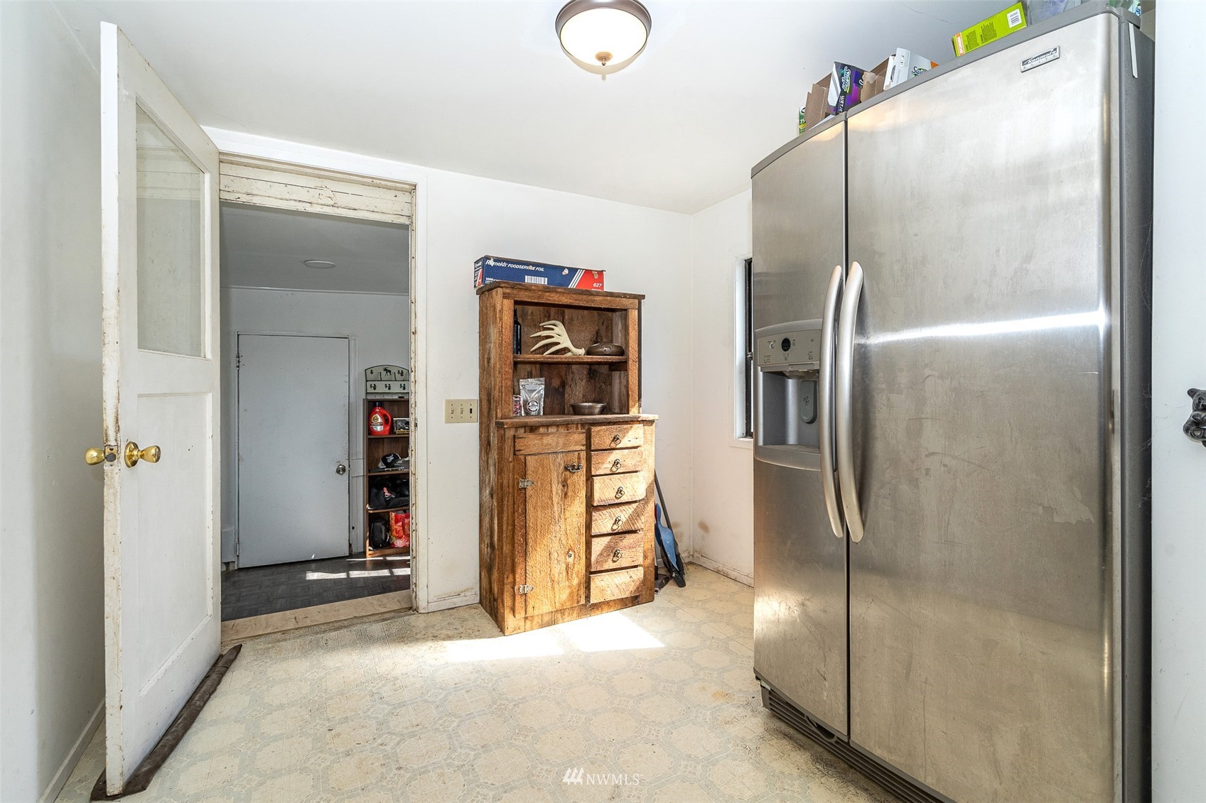 254 Boone Road Toledo, WA 98591 - Photo 7 of 38 a view of a refrigerator in kitchen and an empty room