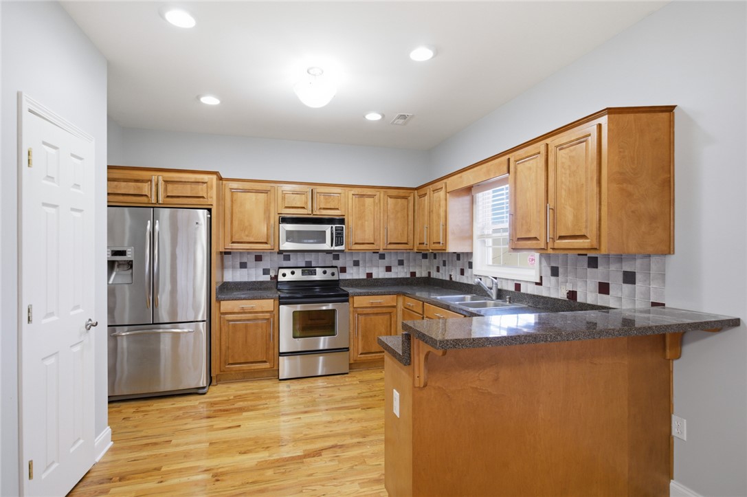 201 Providence Court Seneca, SC 29678 - Photo 11 of 33 This spacious kitchen offers ample cabinet storage and modern appliances for daily living.